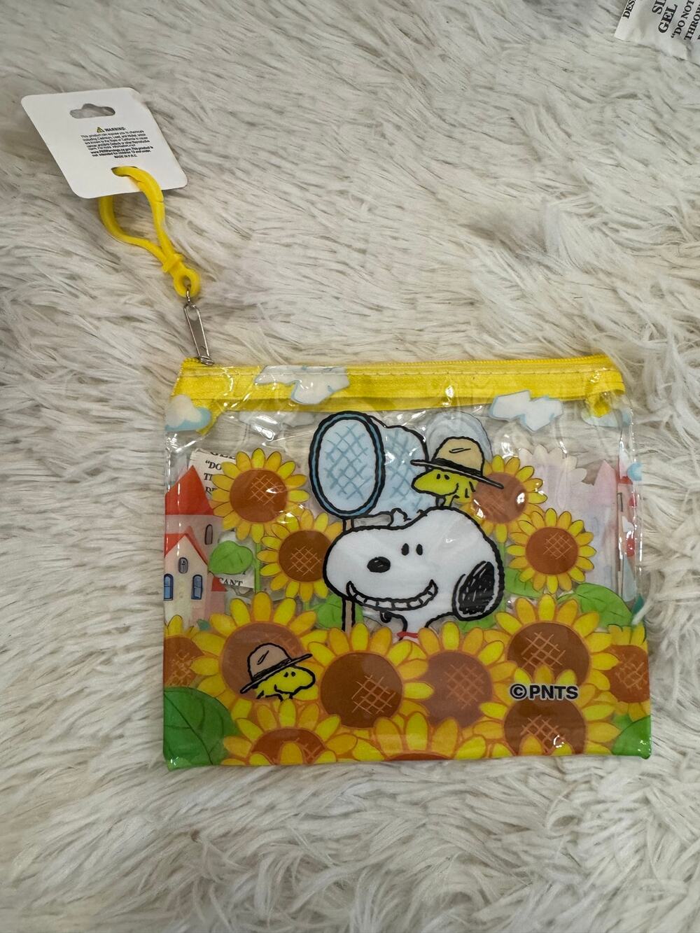 Snoopy clear pouch keychain with Snoopy and Woodstock in a field of sunflowers
